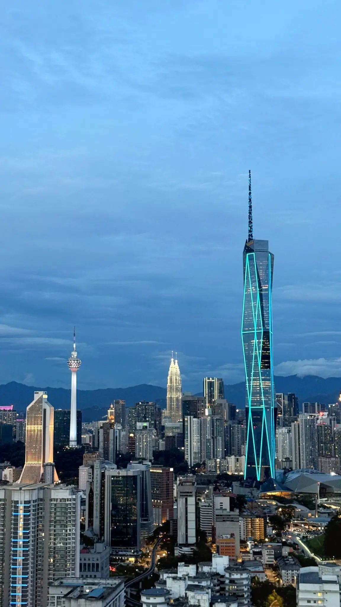 Merdeka 118, Petronas Towers and KL Tower in the skyline at dusk